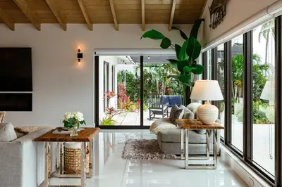 a living room with a couch and a table at Palm Pointe - One third of a mile to the beach - Heated Pool - Intracoastal Views in Fort Lauderdale