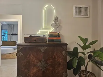 a room with a statue on a dresser with a mirror at -Disco Bungalow- One third mile to FTL Marine Center in Fort Lauderdale