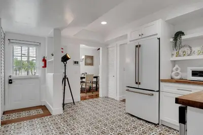 a kitchen with a refrigerator and a camera in it at Casa Del Sol Cozy 2br Retreat 10 Mins To Beach in Miami