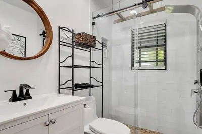 a bathroom with a shower and a toilet and a sink at Casa Del Sol Cozy 2br Retreat 10 Mins To Beach in Miami