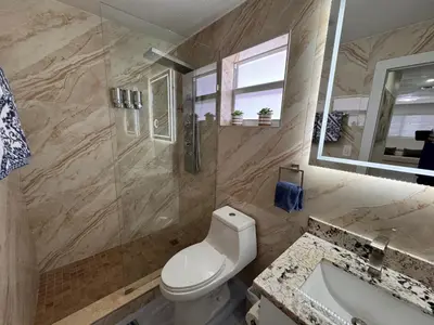 a bathroom with a toilet and a shower and a sink at Stylish 2 Bedrooms Apartment by Miami Airport in Miami