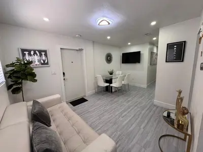 a living room with a couch and a table at Stylish 2 Bedrooms Apartment by Miami Airport in Miami