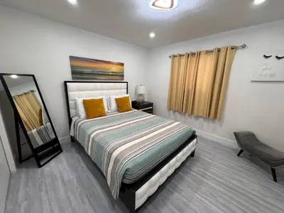 a bedroom with a bed and a mirror in it at Stylish 2 Bedrooms Apartment by Miami Airport in Miami