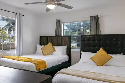 a bedroom with two beds and a ceiling fan at Casa Fillmore - Hollywood Oasis in Hollywood