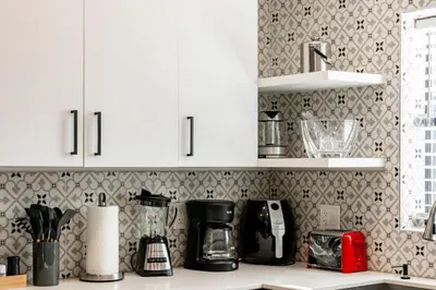 a kitchen with white cabinets and a counter top at Casa Fillmore - Hollywood Oasis in Hollywood