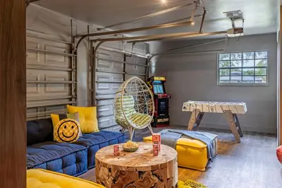 a living room with a blue couch and a table at Villa Tation 8BR Mini Hotel in Plantation