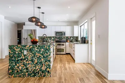 a kitchen with white cabinets and a counter top at Villa Tation 8BR Mini Hotel in Plantation