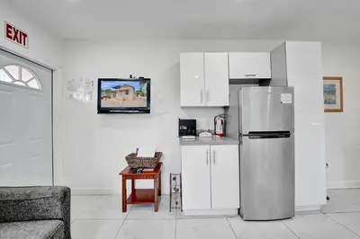 a kitchen with a refrigerator and white cabinets at Seaside Beach House in Hollywood