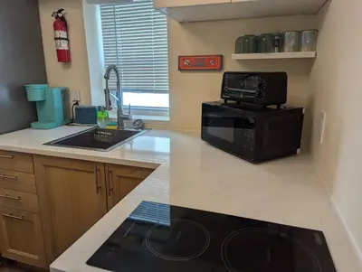 a kitchen with a microwave and a sink and a stove at Beach Breeze Suite - Steps to the Beach in Hollywood