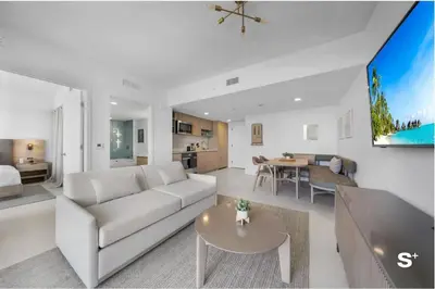 a living room with a white couch and a table at Stylish 1-BD Condo - City Views in Miami
