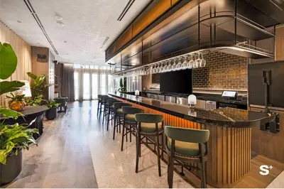 a bar with a bunch of stools in a restaurant at Stylish 1-BD Condo - City Views in Miami