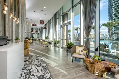 a lobby of a building with windows and chairs at 2 BR Apartment with Amenities and Balcony in Hollywood