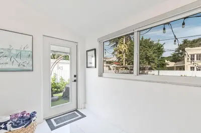 a white room with windows and a basket of shoes at Casa Belle 3br W Pool & Bbq 10 Mins To Beach in Miami