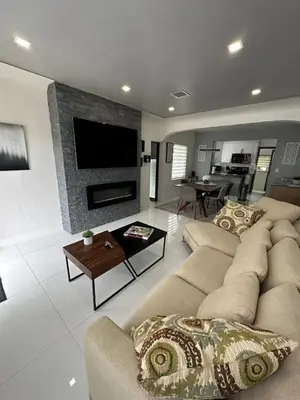 a living room with a couch and a fireplace at Casa Belle 3br W Pool & Bbq 10 Mins To Beach in Miami
