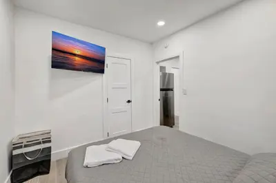 a bedroom with a bed and a painting on the wall at Banyan St. 1BR 1BA off Las Olas - Steps to Beach in Fort Lauderdale