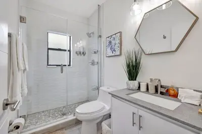 a white bathroom with a toilet and a shower at 3BR 2.5BA Townhome-10 mins to FTL Beach and Downtown in Fort Lauderdale