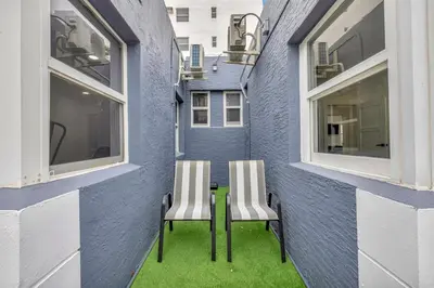 two chairs sitting on a table next to a building at Banyan St 2BR 1BA off Las Olas- Steps to Beach unit 4 in Fort Lauderdale