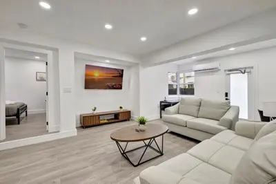 a living room with a couch and a table at Banyan St 2BR 1BA off Las Olas- Steps to Beach unit 4 in Fort Lauderdale