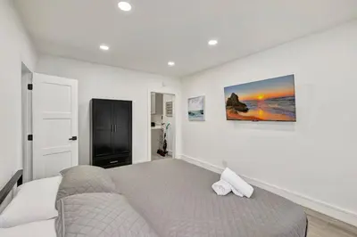 a bedroom with a bed with two white towels on it at Banyan St. Studio off Las Olas- Steps to the Beach in Fort Lauderdale
