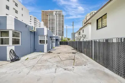 an empty street with buildings and a fence at Banyan St. Studio off Las Olas- Steps to the Beach in Fort Lauderdale
