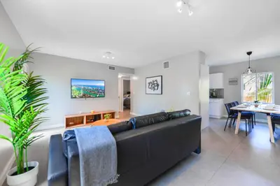 a living room with a couch and a dining room at Comfy & Spacious Duplex w Top Amenities! in Miami