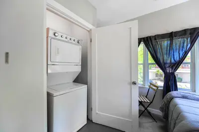 a white bedroom with a bed and a window at Comfy & Spacious Duplex w Top Amenities! in Miami