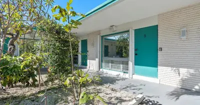 a front door of a house with a blue door at Beachside Studio in Hollywood