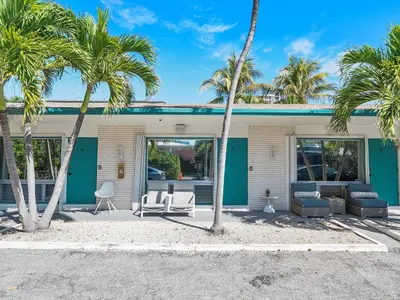 a house with palm trees in front of it at Beachside Studio in Hollywood
