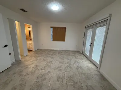an empty room with white walls and a large door at 1644 Jackson St, Hollywood, FL 33020 in Hollywood