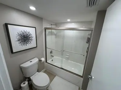 a bathroom with a toilet and a glass shower at Urban Luxe Aventura 22 Retreat in Aventura