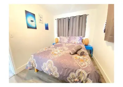 a bedroom with a bed with a purple comforter at Cozy Place Near Design District - 2 in Miami