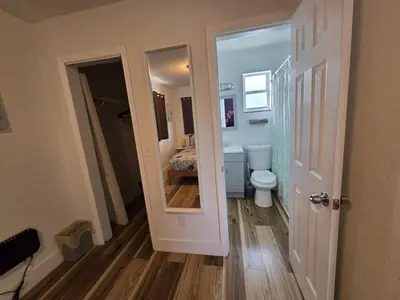 a small bathroom with a toilet and a mirror at Cozy Place Near Design District - 4 in Miami