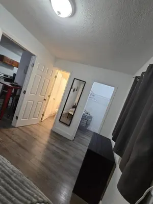 a living room with a mirror and a door at Cozy Place Near Design District - 3 in Miami