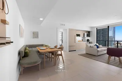 a kitchen and living room with a table and chairs at Modern Stylish Apt 2BR-2BTH in Miami