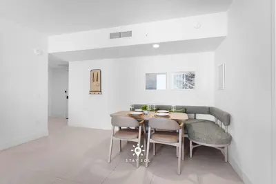a dining room with a table and chairs at Modern Stylish Apt 2BR-2BTH in Miami