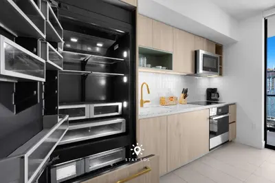 a kitchen with stainless steel appliances and a black refrigerator at Modern Stylish Apt 2BR-2BTH in Miami