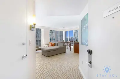 a living room with a couch and a view of a city at Unique Apartment Miami Views in Sunny Isles Beach