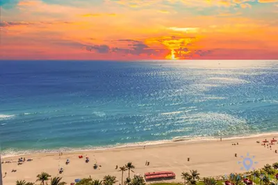 a view of a beach with people and the ocean at Unique Apartment Miami Views in Sunny Isles Beach