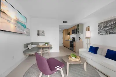 a living room with a couch and a table at 1BR Apartment - Pool & Gym in Miami