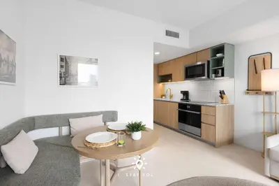 a living room with a table and a kitchen at 1BR Apartment - Pool & Gym in Miami