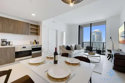 a kitchen and living room with a table and chairs at 1 BR - City Views Gym & Pool in Miami