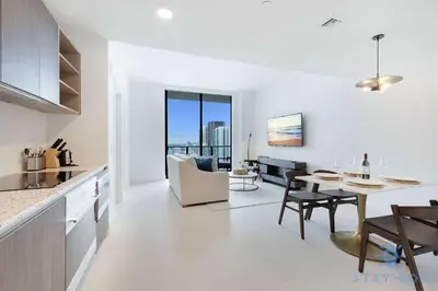 a kitchen and living room with a table and a dining room at Best Stay - City Views Gym & Pool in Miami