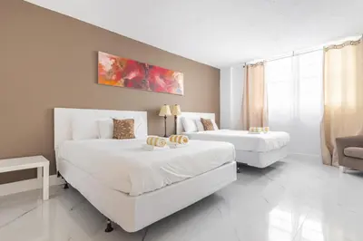 a bedroom with two beds and a couch at Ocean Reserve in South Island