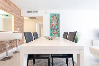 a dining room with a white table and chairs at Ocean Reserve in South Island
