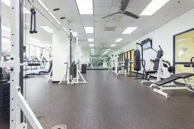 a gym with lots of treadmills and machines at Ocean Reserve in South Island
