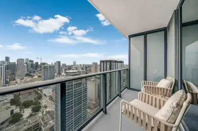 a balcony with two chairs and a view of the city at Lemon Drop - Modern Central & Full Amenities in Miami