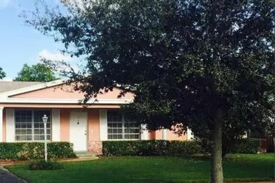 a house with a tree in front of it at Oasis1080 Resort in Plantation