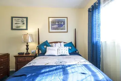 a bedroom with a blue bed and a window at Oasis1080 Resort in Plantation
