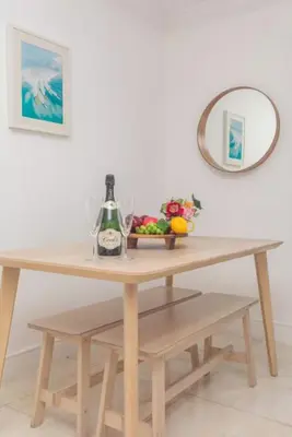 a table with a bottle of wine and a mirror at North Bay in Miami Beach