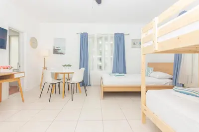 a bedroom with two bunk beds and a table at Ocean Villa in Miami Beach